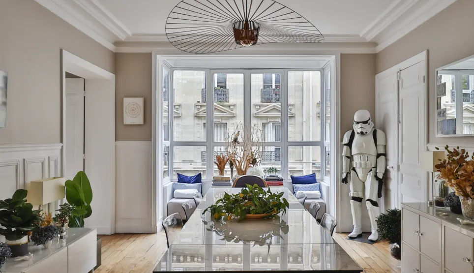 Luxury Parisian apartment: elegant dining room, modern design with a unique Stormtrooper touch. City view, bright interiors.