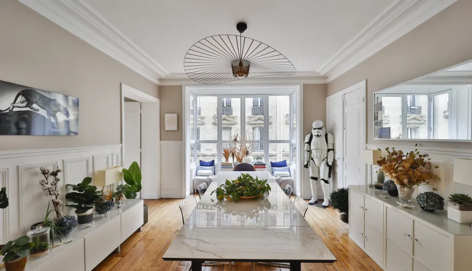 Luxury Parisian dining room, modern elegant design. Parquet, moldings, city view. Unique Stormtrooper touch. Refined and distinctive character.