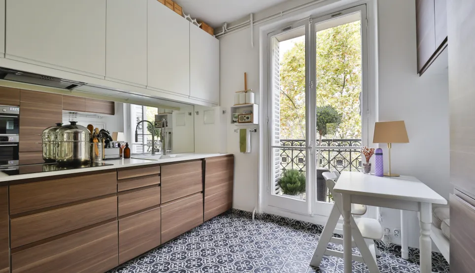 Luxury modern wood/white kitchen, patterned floor, balcony. Elegance and functionality for a prestigious apartment.