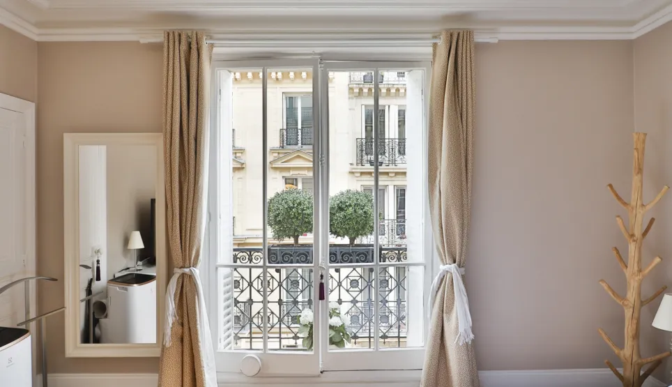 Luxury Parisian bedroom featuring a balcony, hardwood floor, and unique design lighting. Elegant urban retreat.