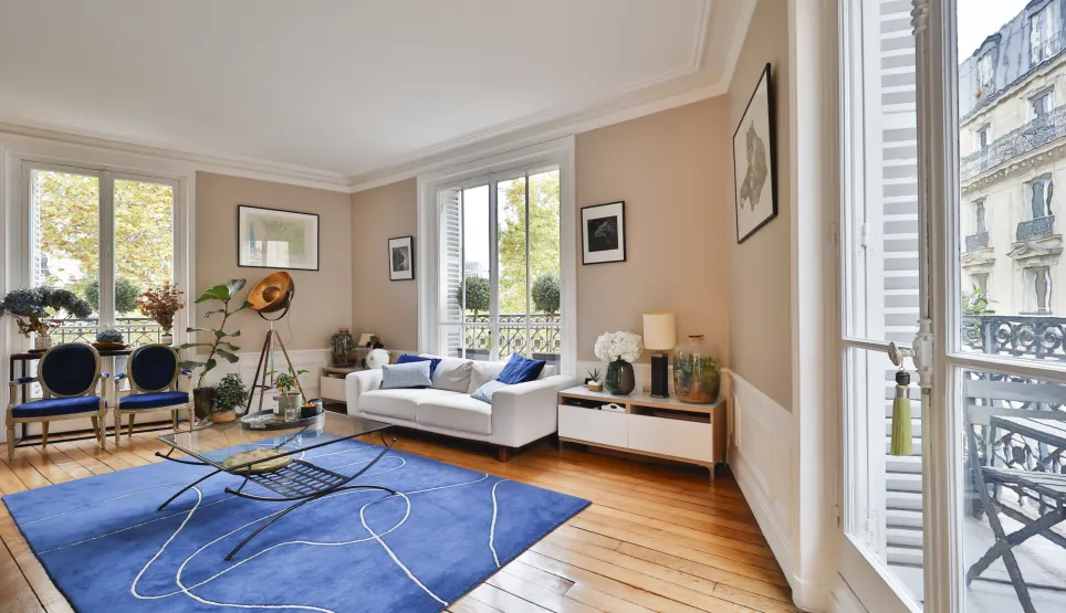 Bright luxury living room, Parisian apartment with balcony. Modern design, hardwood floors, chic ambiance.