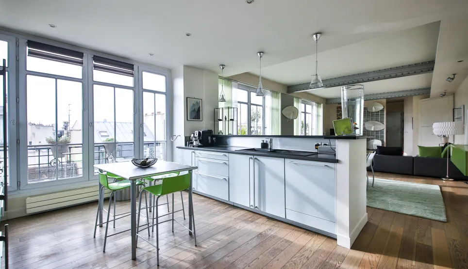 Modern luxury apartment with open kitchen, city view, hardwood floors, and elegant design. Bright, high-end living space.