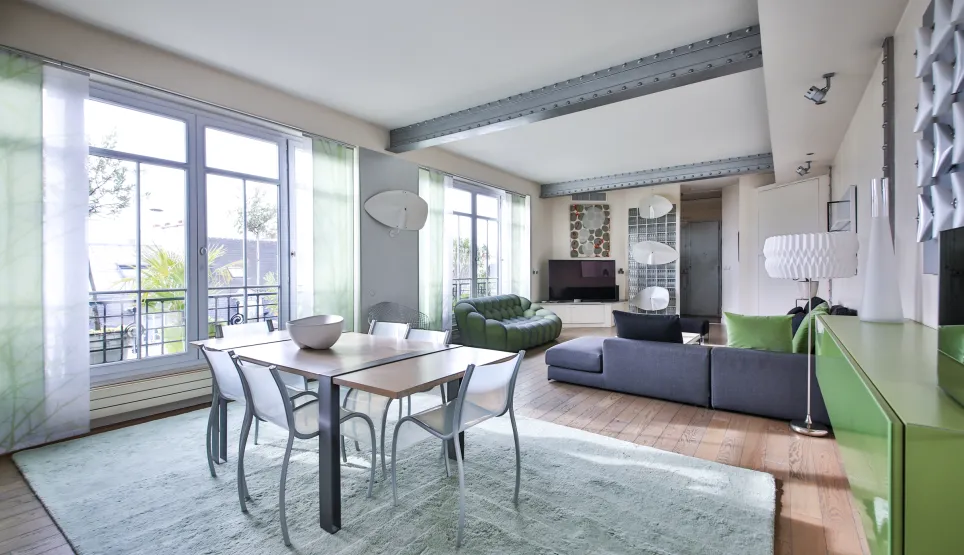 Spacious, bright open-plan living-dining with balcony view. Luxury contemporary apartment, elegant furniture, industrial touches. Modern comfort.