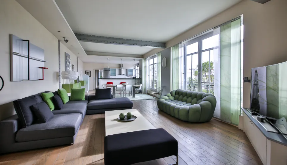 Spacious, bright luxury living room with contemporary design, open kitchen, and clear views. Perfect for a high-end apartment.