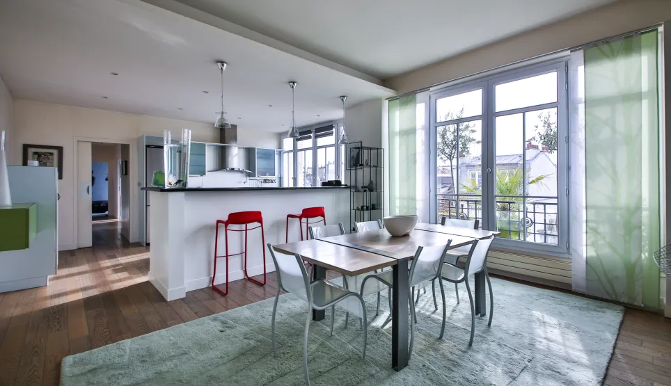 Modern luxury apartment with open kitchen, bright dining area, and scenic views. Contemporary design, hardwood floors, and large windows.