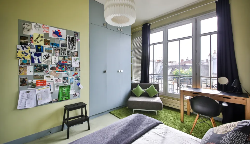 Modern luxury bedroom, bright, city view. Contemporary design, desk, built-in storage. Ideal urban apartment.