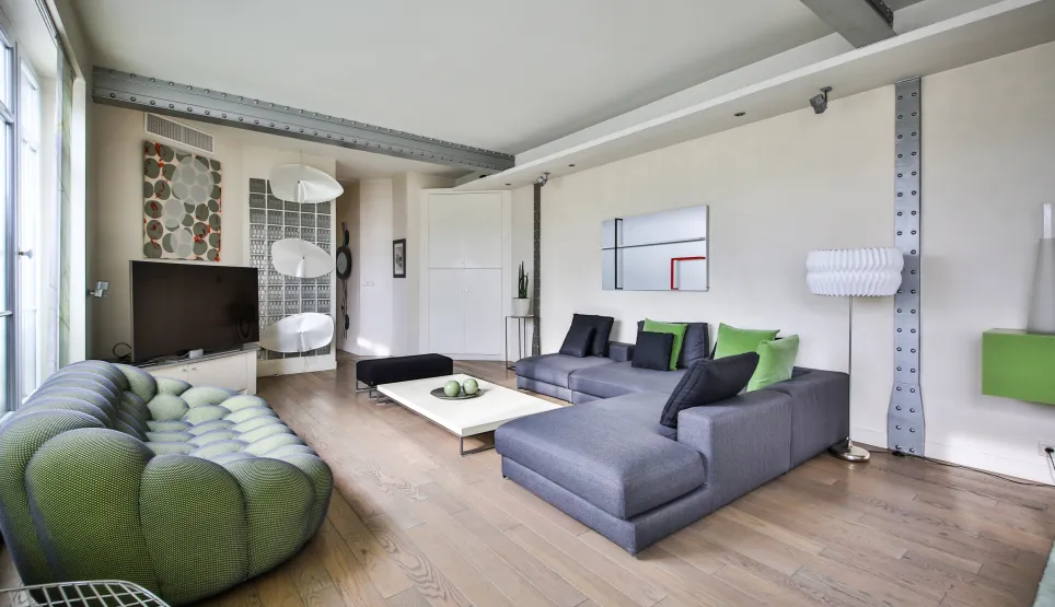 Luxurious modern living room with designer sofas, light wood floor, and industrial beams. Elegant and contemporary living space.