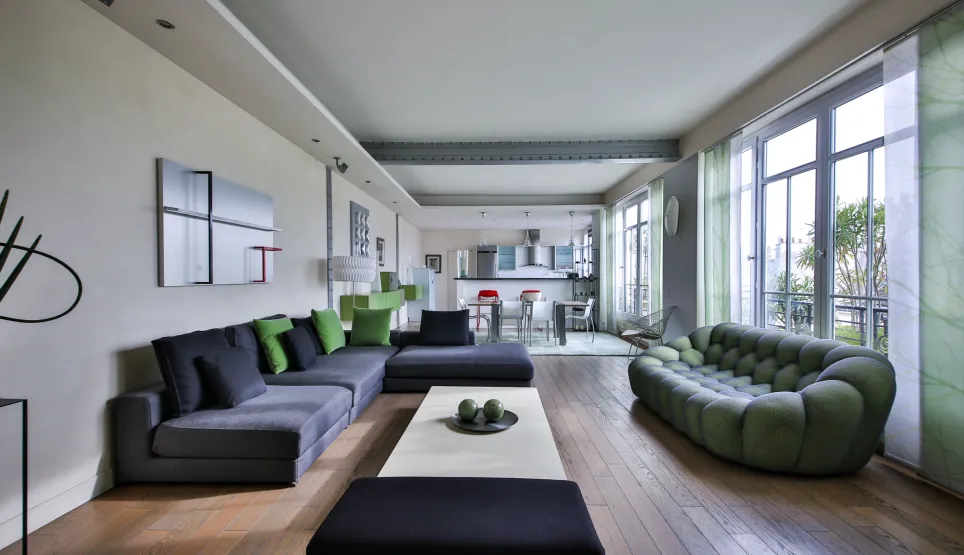 Modern luxury living room with designer sofas, hardwood floors, open kitchen. Spacious, bright apartment for contemporary living.