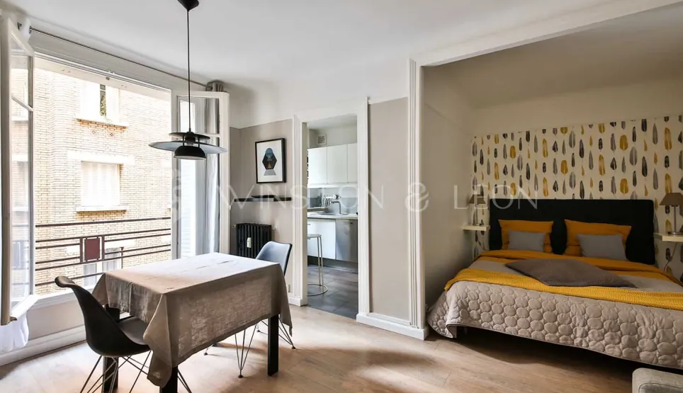 Modern luxury apartment. Chic open-plan studio with cozy bedroom, dining, and modern kitchen. Contemporary elegance and bright living.