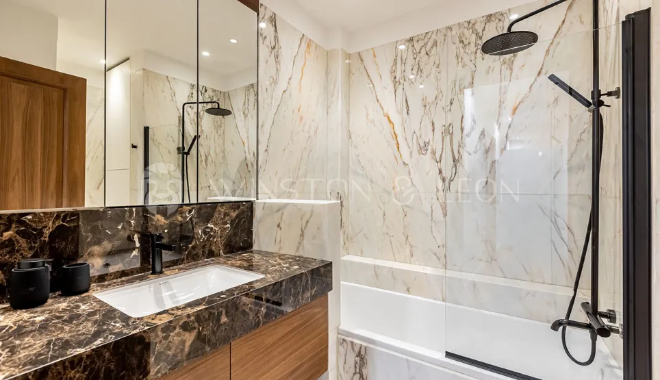 Modern luxury bathroom. Elegant marble, designer vanity, shower/bathtub. Refined ambiance, noble materials.