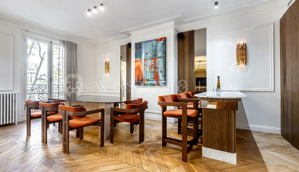 Luxury apartment: designer dining and bar area, herringbone parquet, modern art. Elegant, bright space for entertaining.