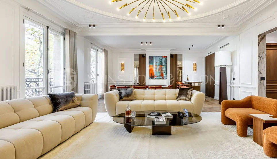 Contemporary luxury living room with designer furniture, high ceilings, large windows, and art. Elegance and comfort for an exceptional interior.
