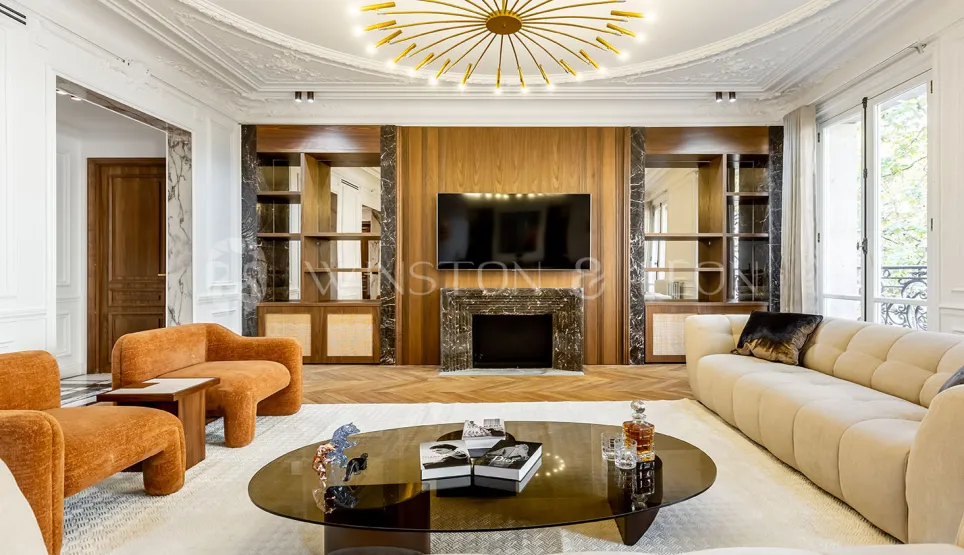 Elegant luxury living room, contemporary design, wood paneling & marble fireplace. High-end Parisian apartment. Refined ambiance.