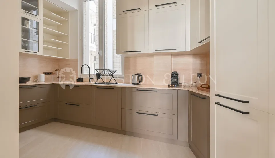 Luxury modern two-tone kitchen (beige/taupe), sleek design, premium finishes. Ideal for a contemporary apartment.
