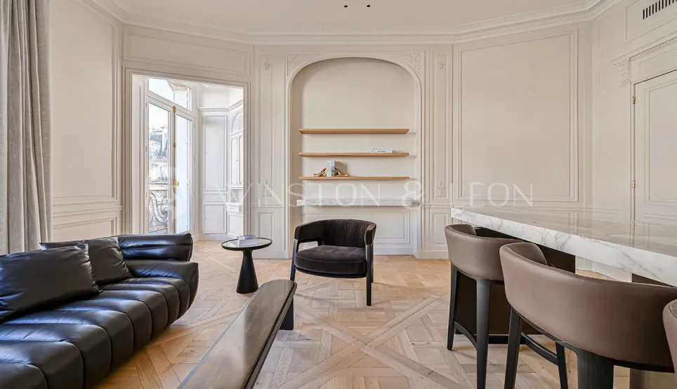 Luxurious Parisian Haussmannian living room. Modern & classic design, parquet, moldings, marble, high-end furniture. Timeless elegance.