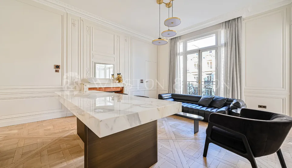 Luxury Parisian living room. Modernized Haussmannian design, marble, parquet, moldings. Elegance and prestige for a refined interior.