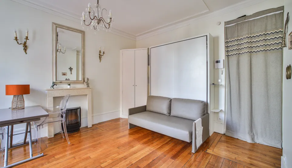 Elegant, bright Parisian studio. Hardwood, fireplace, designer murphy bed. Luxury space optimization. Ideal investment.