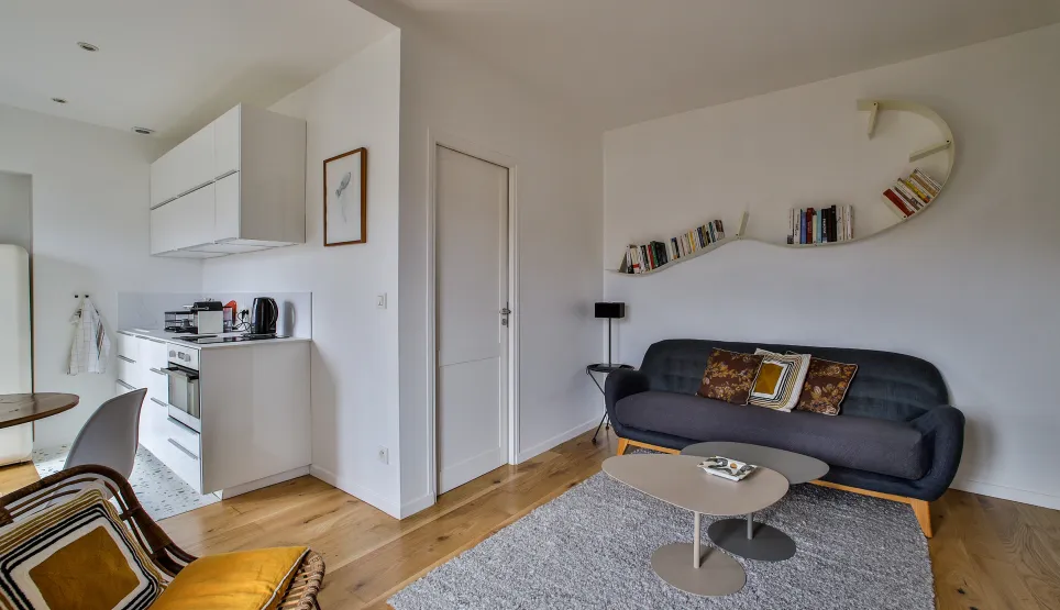 Modern luxury apartment: bright living room, open-plan designer kitchen, hardwood floors. Contemporary & elegant space.