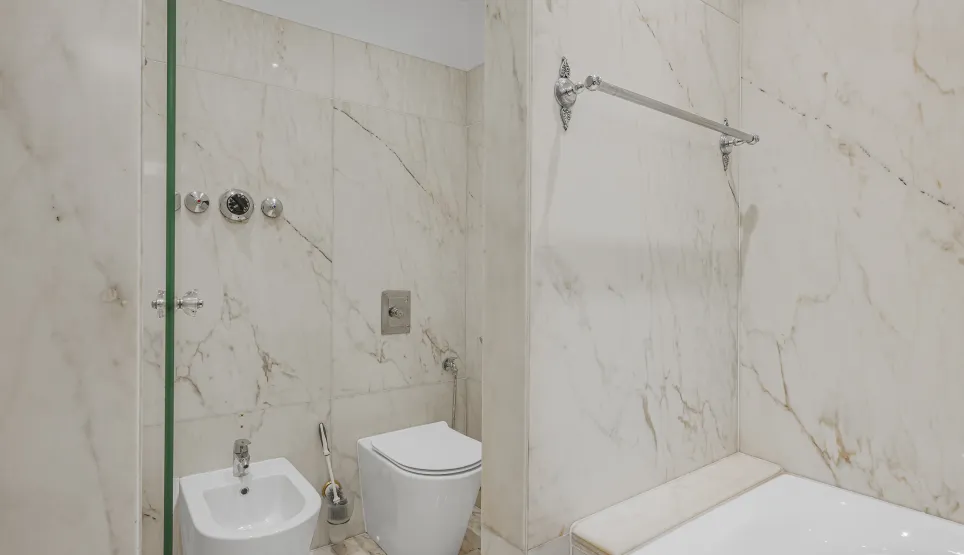 Luxury marble bathroom with shower, bathtub, toilet, and bidet. Elegant design and high-end finishes.