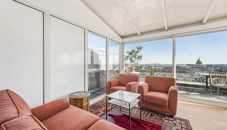 Luxury penthouse in Paris with panoramic Invalides view and sunny terrace. Elegant and bright living room.