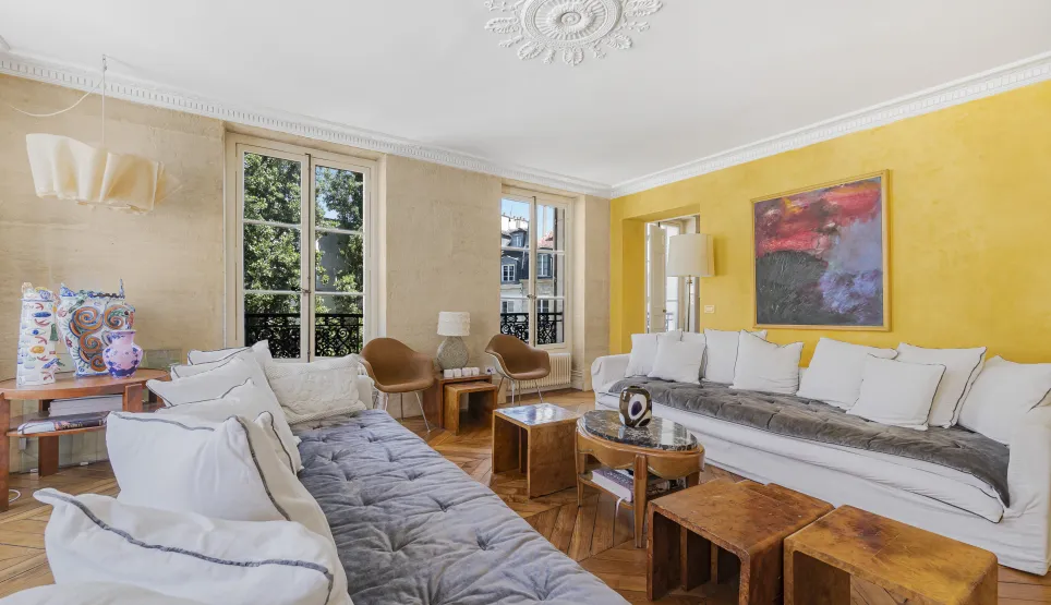 Stunning luxury living room featuring parquet, moldings, large windows, and contemporary design. Perfect for an elegant Parisian apartment.