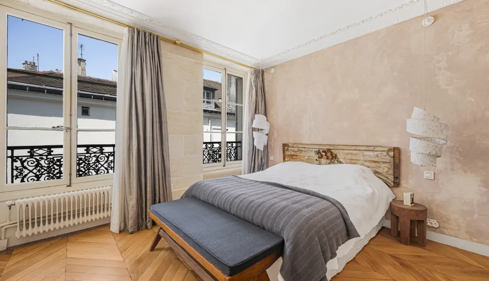 Luxury Parisian bedroom. Parquet, city view, elegant and comfortable design. Refined ambiance.