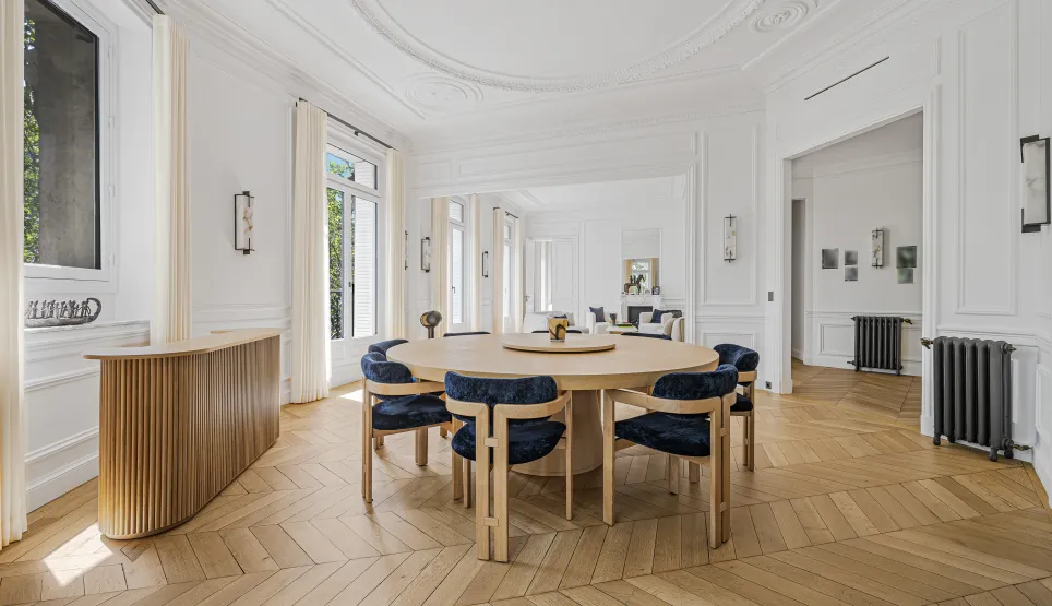 Bright luxury dining room, elegant design. Parisian apartment with herringbone parquet, moldings. Refinement and space.