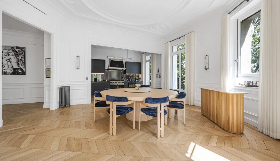 Bright luxury apartment with contemporary dining room, modern open kitchen, and chevron parquet. Elegant and spacious design.