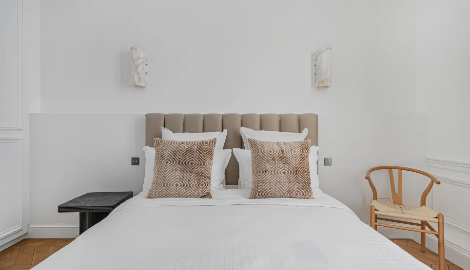 Elegant luxury bedroom, contemporary minimalist design, comfortable bed, neutral tones. Perfect for a high-end apartment or boutique hotel.