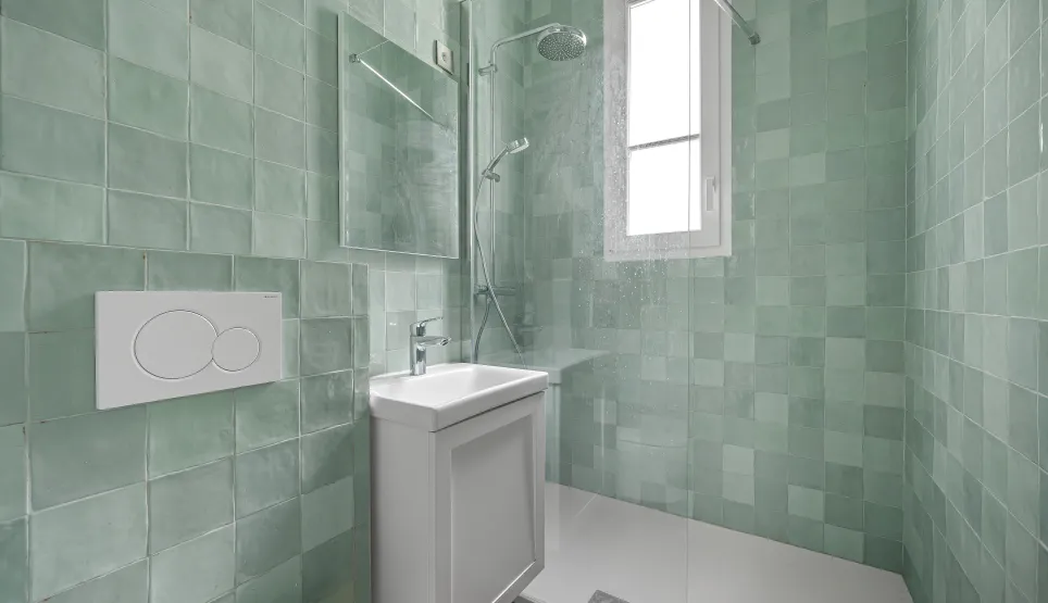 Contemporary bathroom with walk-in shower, bright mint green tiles. Minimalist design for a modern luxury interior.