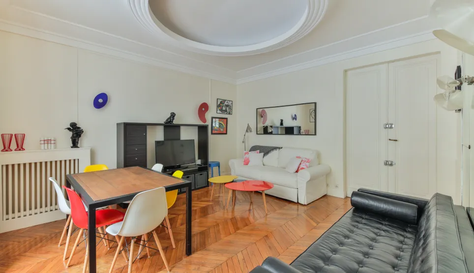 Modern luxury living-dining room. Parquet flooring, colorful designer furniture, bright space. Ideal for a prestigious apartment.