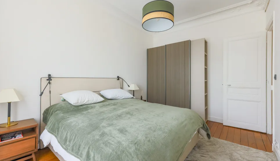 Elegant modern bedroom featuring a double bed, integrated storage, and sleek design. Perfect for a luxury apartment or high-end residence.