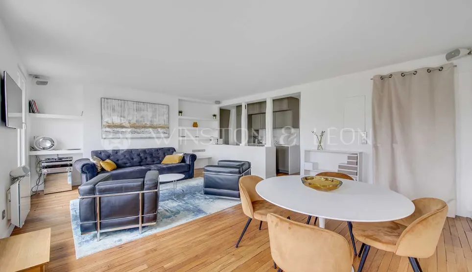 Bright modern living & dining room. Velvet sofa, design armchairs, oval table. Chic contemporary interior for luxury property.