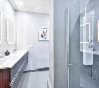 Modern luxury bathroom featuring double vanity, LED mirrors, and glass shower. Sleek design, high-end finishes for an exclusive property.