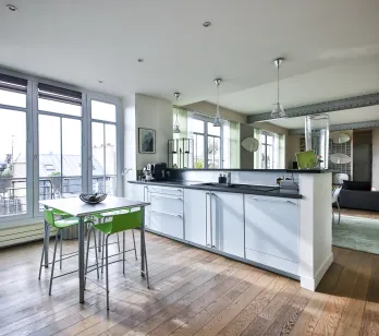 Modern luxury apartment with open kitchen, city view, hardwood floors, and elegant design. Bright, high-end living space.