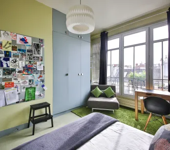 Modern luxury bedroom, bright, city view. Contemporary design, desk, built-in storage. Ideal urban apartment.