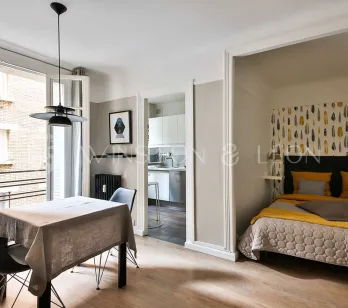 Modern luxury apartment. Chic open-plan studio with cozy bedroom, dining, and modern kitchen. Contemporary elegance and bright living.
