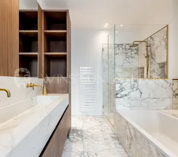 Modern luxury bathroom: white marble, double vanity, gold fixtures, walk-in shower and bathtub. Elegant design.