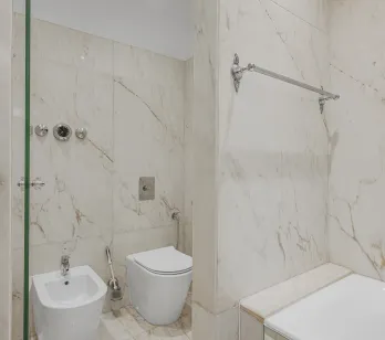 Luxury marble bathroom with shower, bathtub, toilet, and bidet. Elegant design and high-end finishes.