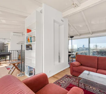 Luxury penthouse: modern, bright living room with panoramic city views, large windows and terrace access. Contemporary design.