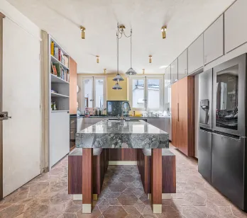 Modern luxury kitchen featuring a stunning marble island, high-end appliances, and elegant design. Perfect for a Parisian apartment.