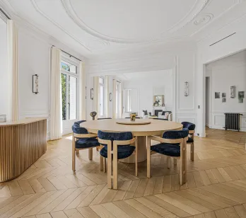 Bright luxury dining room, elegant design. Parisian apartment with herringbone parquet, moldings. Refinement and space.