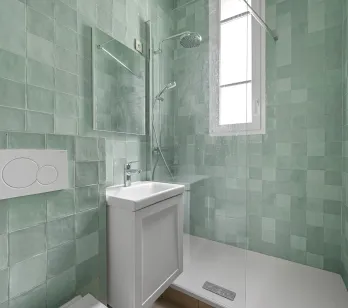 Contemporary bathroom with walk-in shower, bright mint green tiles. Minimalist design for a modern luxury interior.