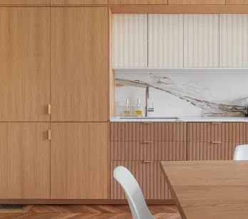 Luxury modern kitchen: light wood, veined marble, gold finishes. Contemporary design with herringbone parquet and Smeg appliance.