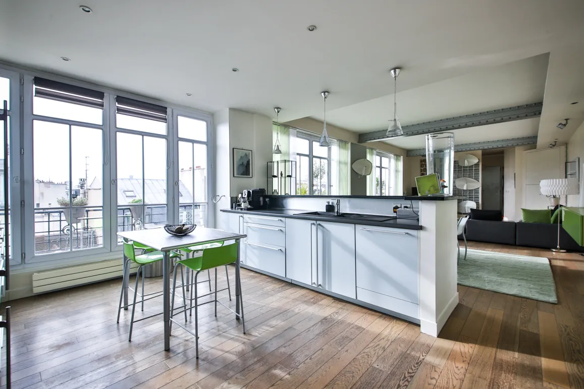 Modern luxury apartment with open kitchen, city view, hardwood floors, and elegant design. Bright, high-end living space.