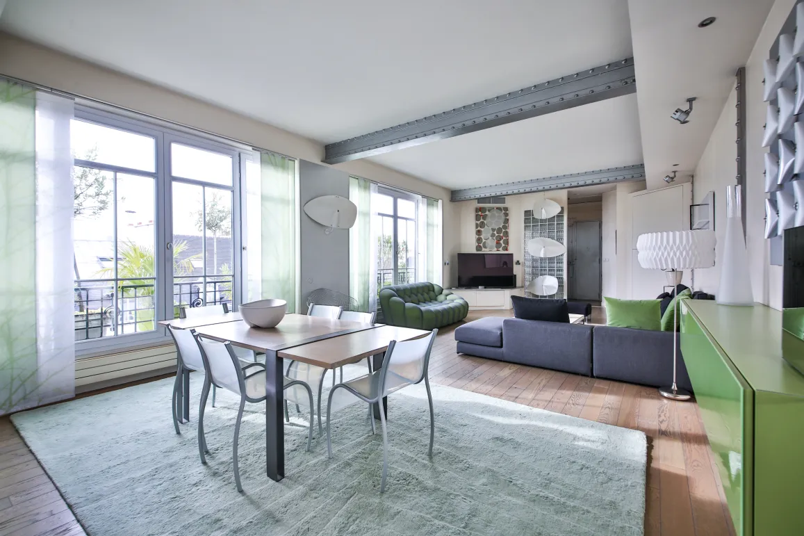 Spacious, bright open-plan living-dining with balcony view. Luxury contemporary apartment, elegant furniture, industrial touches. Modern comfort.