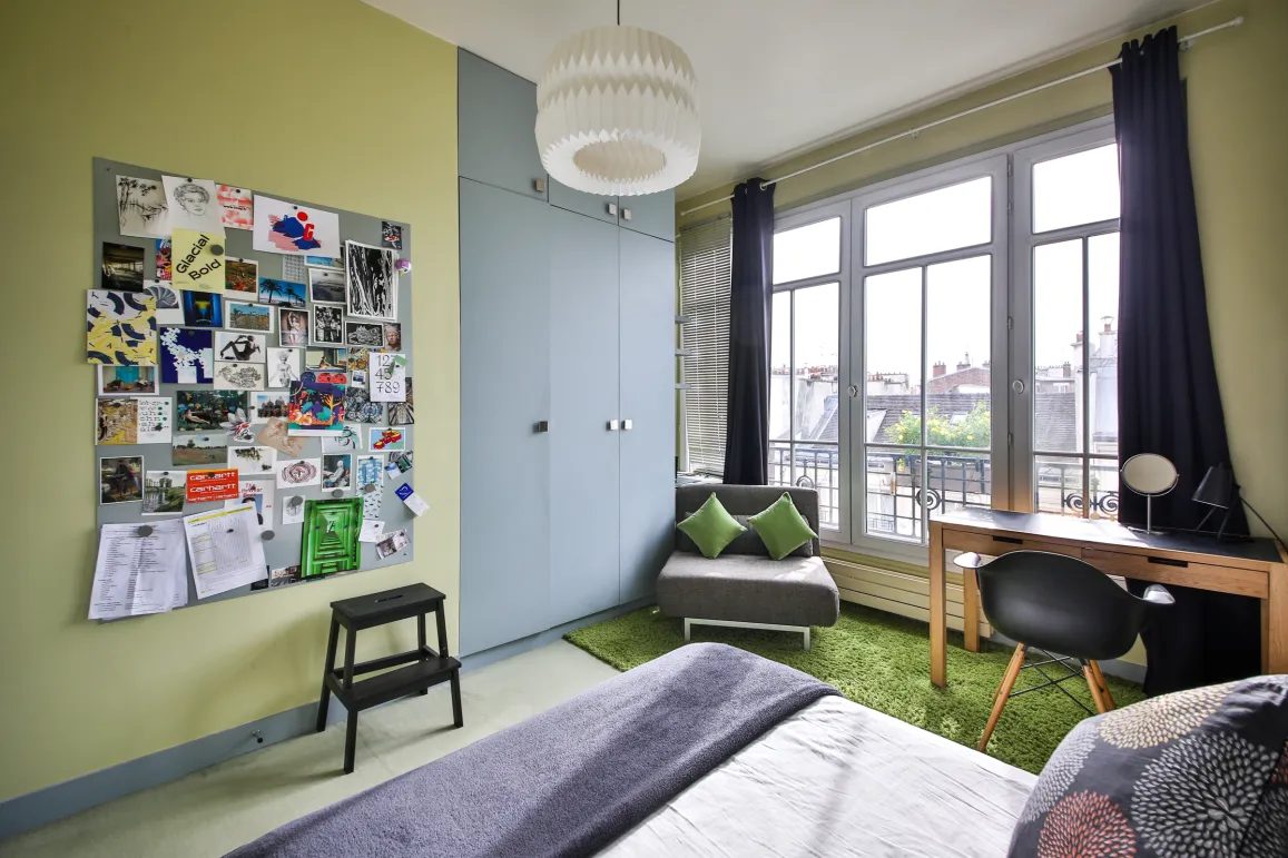 Modern luxury bedroom, bright, city view. Contemporary design, desk, built-in storage. Ideal urban apartment.