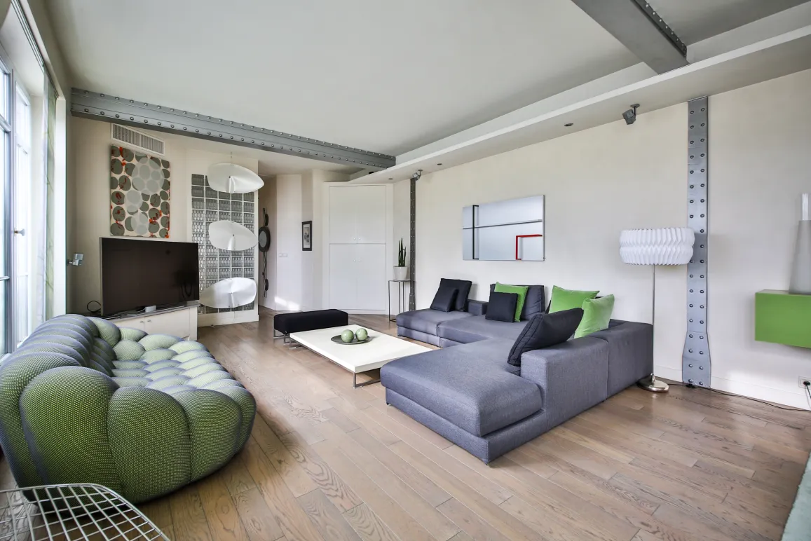 Luxurious modern living room with designer sofas, light wood floor, and industrial beams. Elegant and contemporary living space.