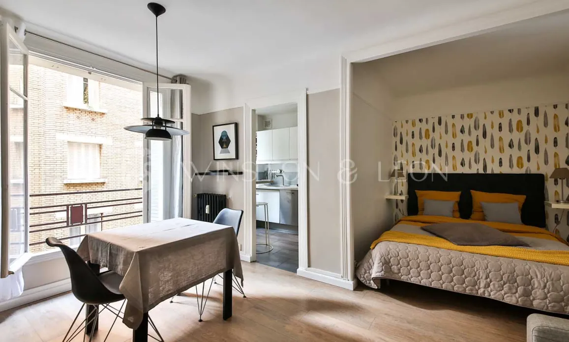 Modern luxury apartment. Chic open-plan studio with cozy bedroom, dining, and modern kitchen. Contemporary elegance and bright living.