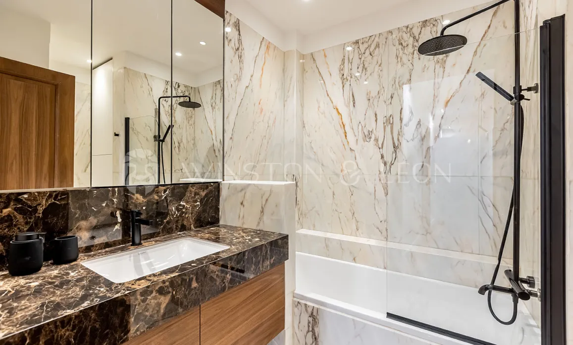 Modern luxury bathroom. Elegant marble, designer vanity, shower/bathtub. Refined ambiance, noble materials.